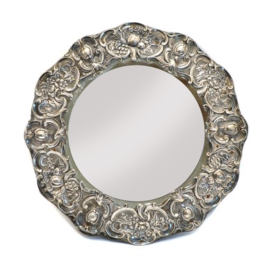Lot 24 - An Edwardian circular silver easel backed dressing table mirror