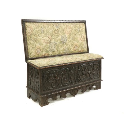 Lot 216 - An Italian carved walnut box settle