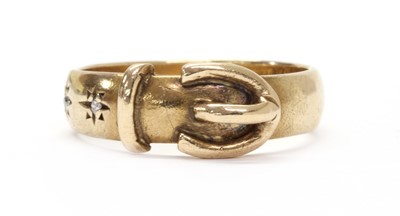Lot 1184 - A 9ct gold diamond set buckle ring