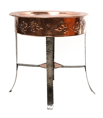 Lot 130 - An Arts and Crafts copper-embossed tray-top table