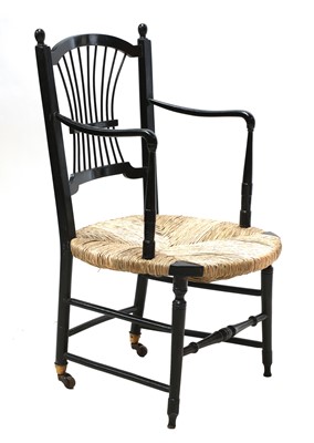 Lot 50 - An ebonised 'Sussex' armchair