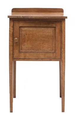 Lot 101 - A Cotswold School oak bedside cupboard