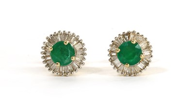 Lot 1266 - A pair of gold emerald and diamond cluster stud earrings