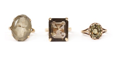 Lot 1246 - Three single stone smoky quartz rings