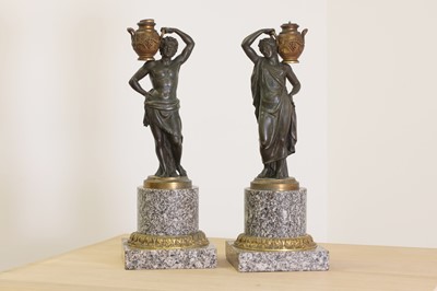 Lot 203 - A pair of bronze figural candlesticks