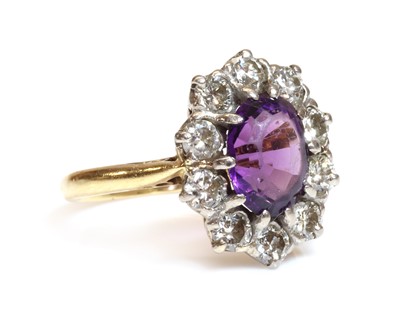Lot 69 - An 18ct gold amethyst and diamond cluster ring, by Arthur & Co., c.1970