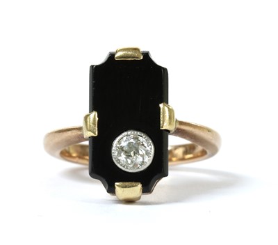 Lot 1045 - A gold diamond and onyx ring