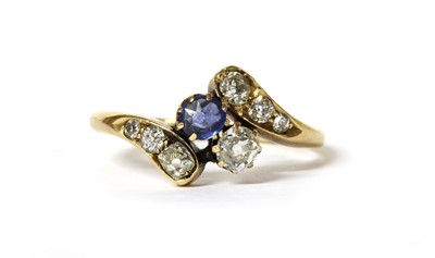 Lot 1026 - An Edwardian gold sapphire and diamond crossover ring
