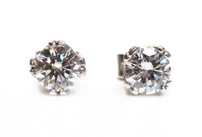 Lot 353 - A pair of white gold single stone diamond stud earrings