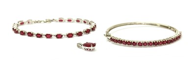 Lot 228 - A sterling silver fracture filled ruby line bracelet