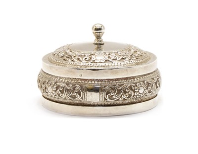 Lot 17 - An Indian white metal jar and cover of squat circular form