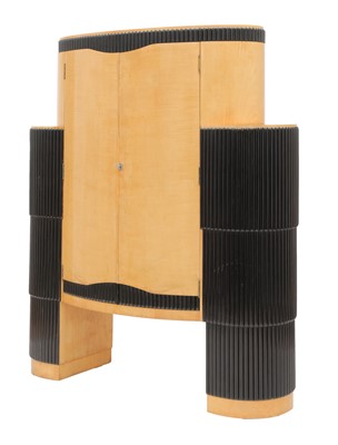 Lot 176 - An Art Deco maple and ebonised ‘Big Bertha’ cocktail cabinet