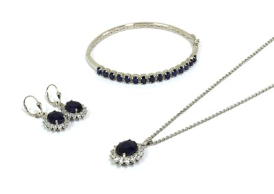 Lot 297 - A sterling silver fracture filled sapphire set bangle