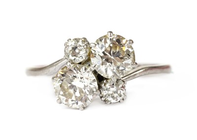 Lot 1199 - A white gold four stone diamond cluster ring