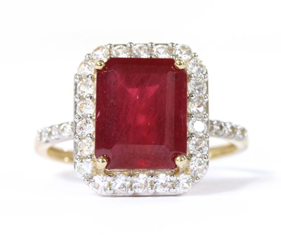 Lot 233 - A 9ct gold fracture filled ruby and zircon halo cluster ring