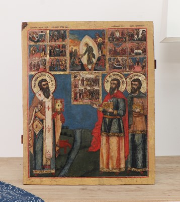 Lot 27 - A large icon of three saints venerating icons