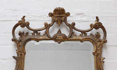 Lot 71 - A George III-style carved giltwood wall mirror