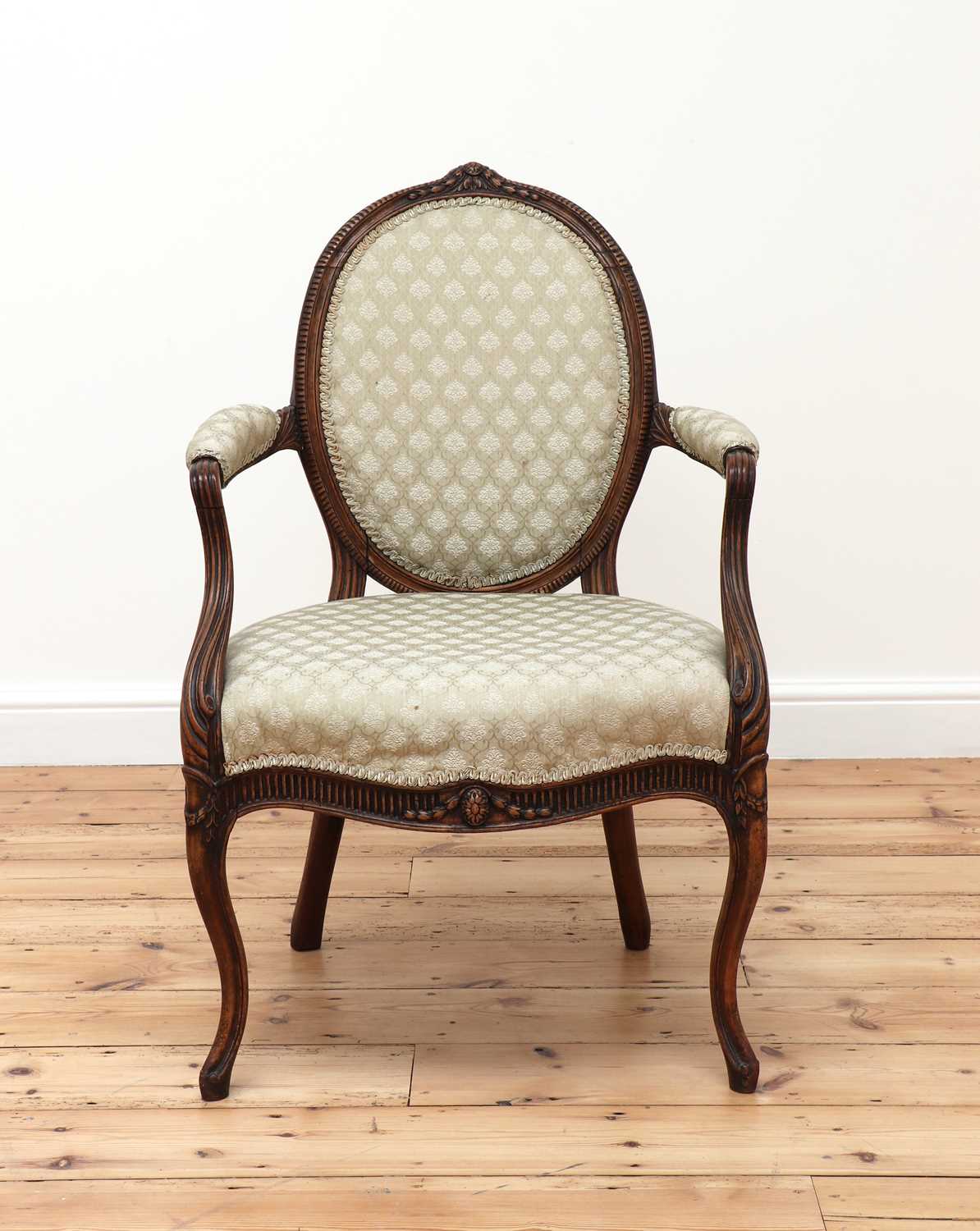Lot 62 - A carved beech open armchair