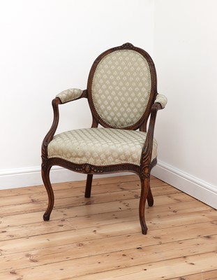 Lot 62 - A carved beech open armchair