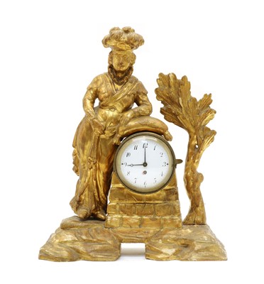 Lot 69 - An 18th century carved pine and gilt figural mantel clock