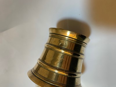 Lot 391 - A graduated set of four bell-shaped brass candlesticks