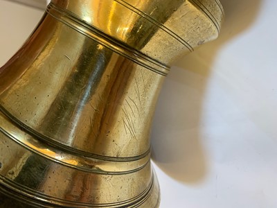 Lot 391 - A graduated set of four bell-shaped brass candlesticks