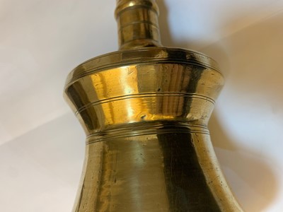 Lot 391 - A graduated set of four bell-shaped brass candlesticks