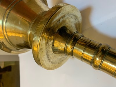 Lot 391 - A graduated set of four bell-shaped brass candlesticks