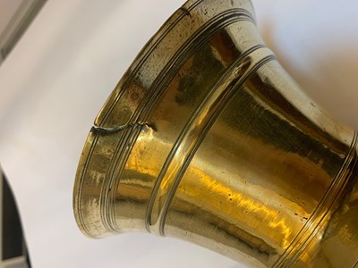 Lot 391 - A graduated set of four bell-shaped brass candlesticks