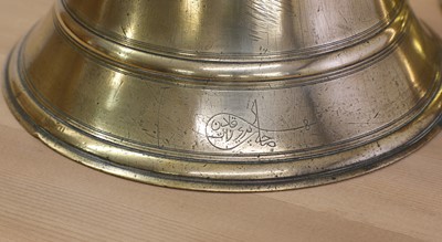 Lot 391 - A graduated set of four bell-shaped brass candlesticks