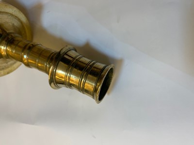 Lot 391 - A graduated set of four bell-shaped brass candlesticks