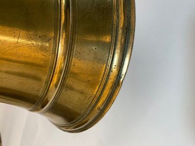 Lot 391 - A graduated set of four bell-shaped brass candlesticks