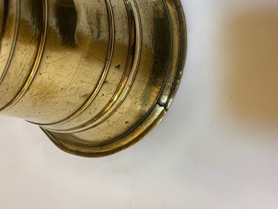Lot 391 - A graduated set of four bell-shaped brass candlesticks