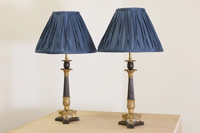 Lot 94 - A pair of French Empire-style patinated and gilt-bronze candlestick lamps