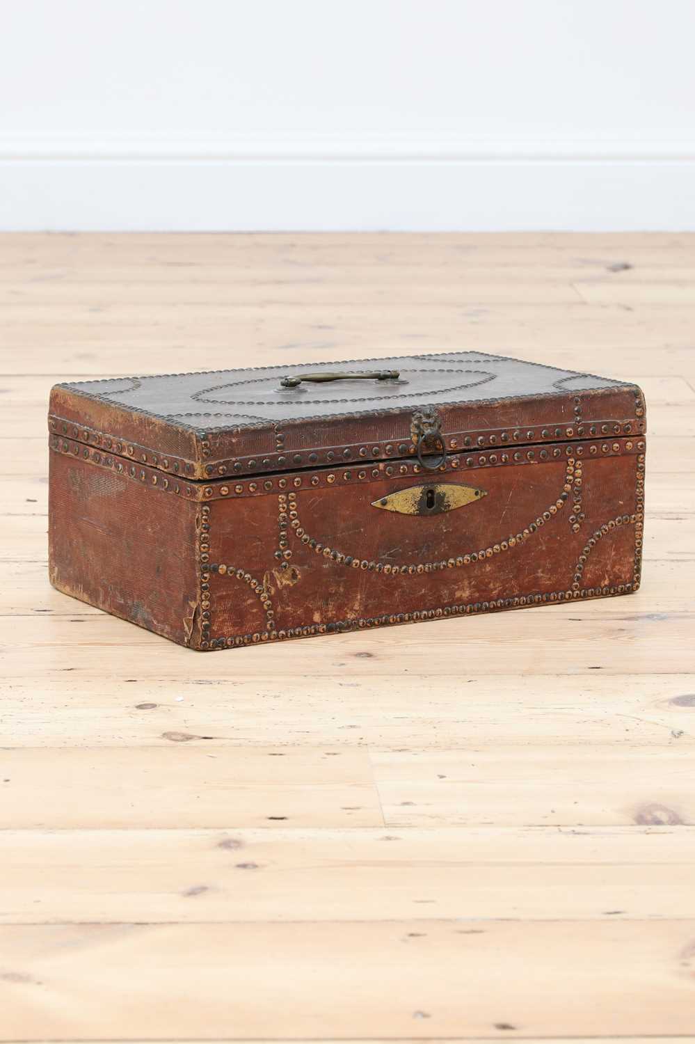 Lot 65 - A red leather and studded deeds box