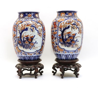 Lot 145 - A pair of Japanese Imari vases on stands