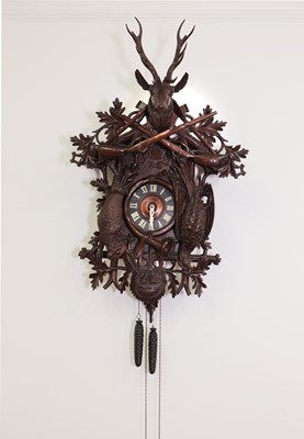 Lot 398 - A large carved Black Forest wall-hanging cuckoo clock