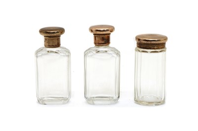 Lot 30 - A set of three 9ct gold mounted faceted glass toilet jars