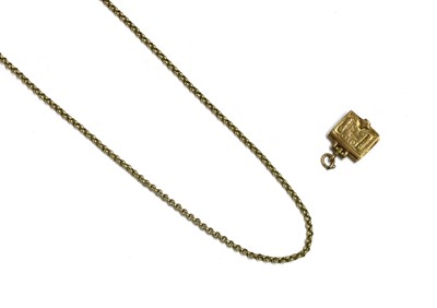 Lot 108 - A 9ct gold articulated Bible charm