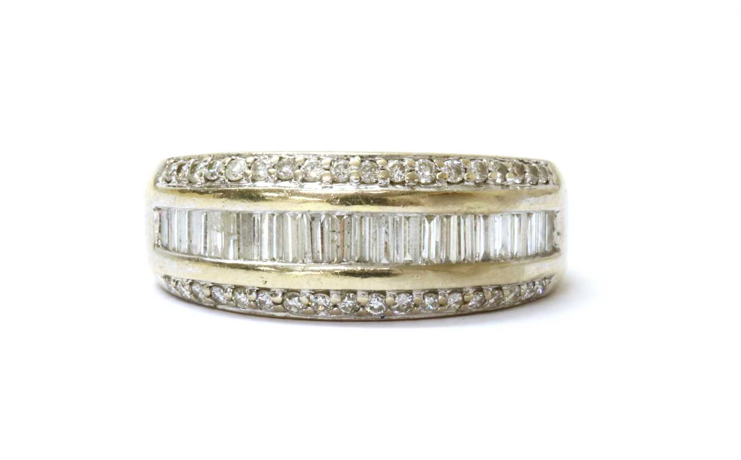 Lot 78 - An 18ct white gold three row diamond set half hoop ring
