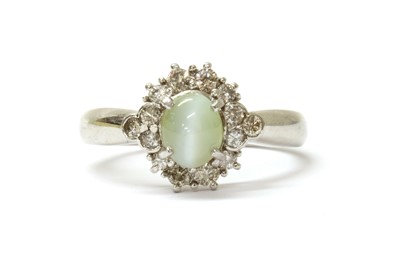 Lot 212 - A platinum cat's eye chrysoberyl and diamond cluster ring