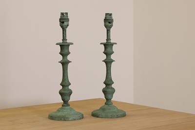 Lot 405 - A pair of verdigris candlestick lamps