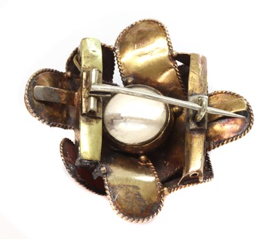 Lot 57 - A Victorian garnet set ribbon style knot brooch