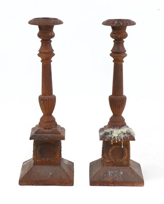 Lot 227 - A pair of cast iron candlesticks
