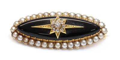 Lot 114 - A Victorian gold marquise shaped onyx brooch