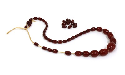 Lot 67 - A single row graduated cherry coloured Bakelite bead necklace