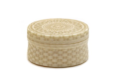 Lot 129 - A carved cylindrical ivory box and hinged cover