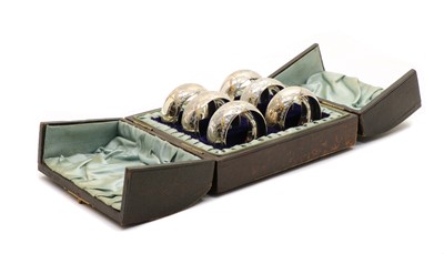Lot 7 - A cased set of six silver napkin rings