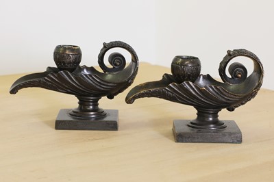 Lot 215 - A pair of grand tour bronze candlesticks