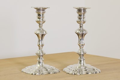 Lot 635 - Two George II cast silver candlesticks